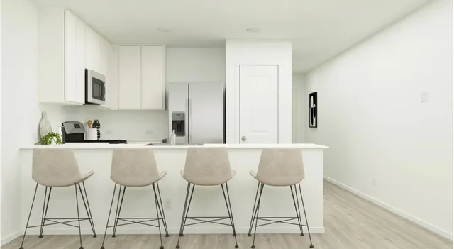 a kitchen with stainless steel appliances a stove microwave and sink