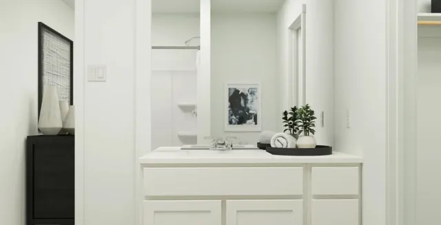 a bedroom with a bed table flowerpot and a window