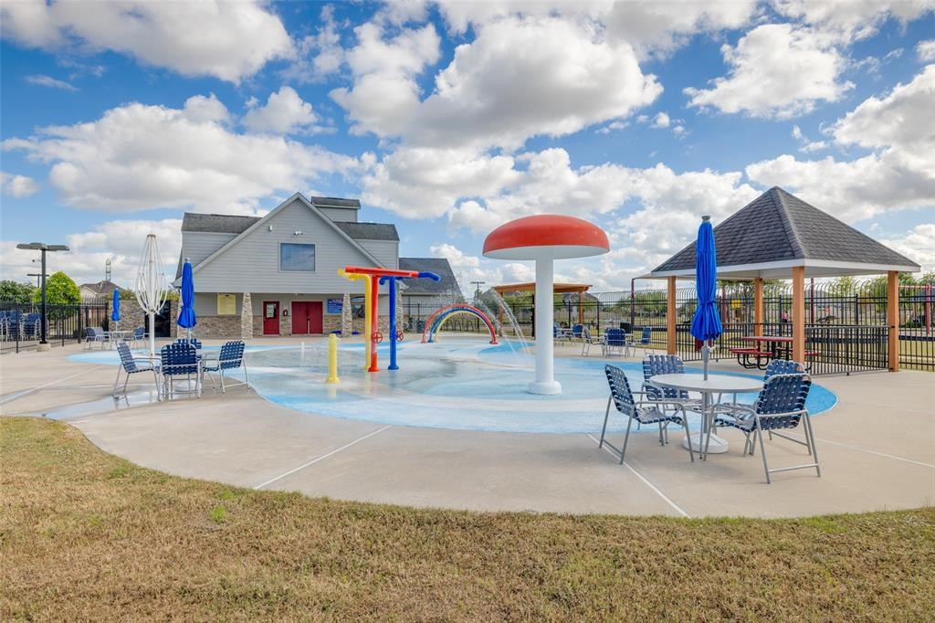 2403 Cherry Ruby Drive Rosharon, TX 77583 - Photo 29 of 30 a view of a patio with a table and chairs under an umbrella