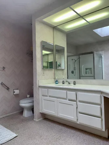 a bathroom that has a glass shower door