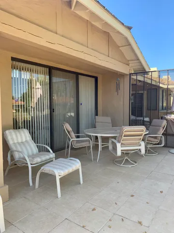 a view of a patio with a table and chairs