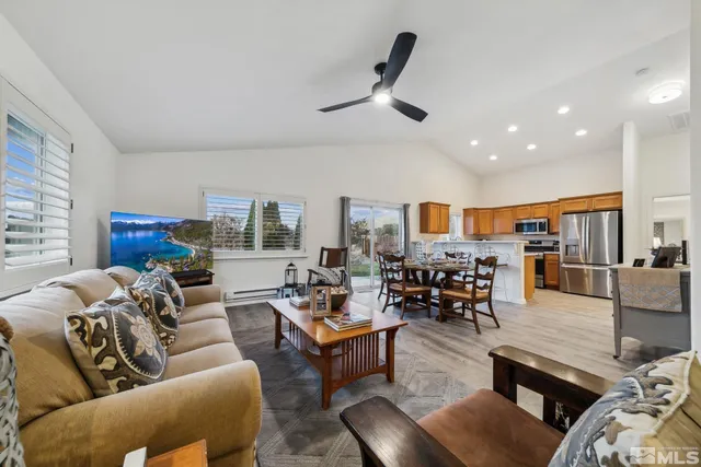a living room with furniture and kitchen view