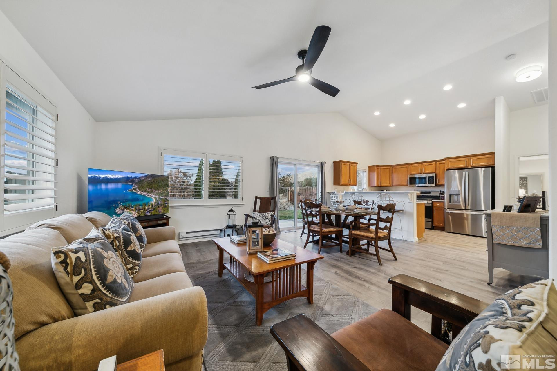a living room with furniture and kitchen view