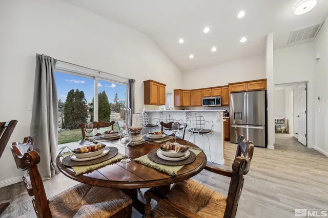 a open dining room with furniture window and wooden floor