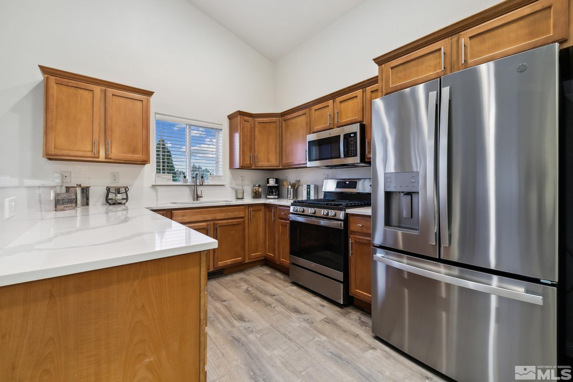 10 Conner Way Gardnerville, NV 89410 - Photo 22 of 40 a kitchen with stainless steel appliances a refrigerator sink and stove