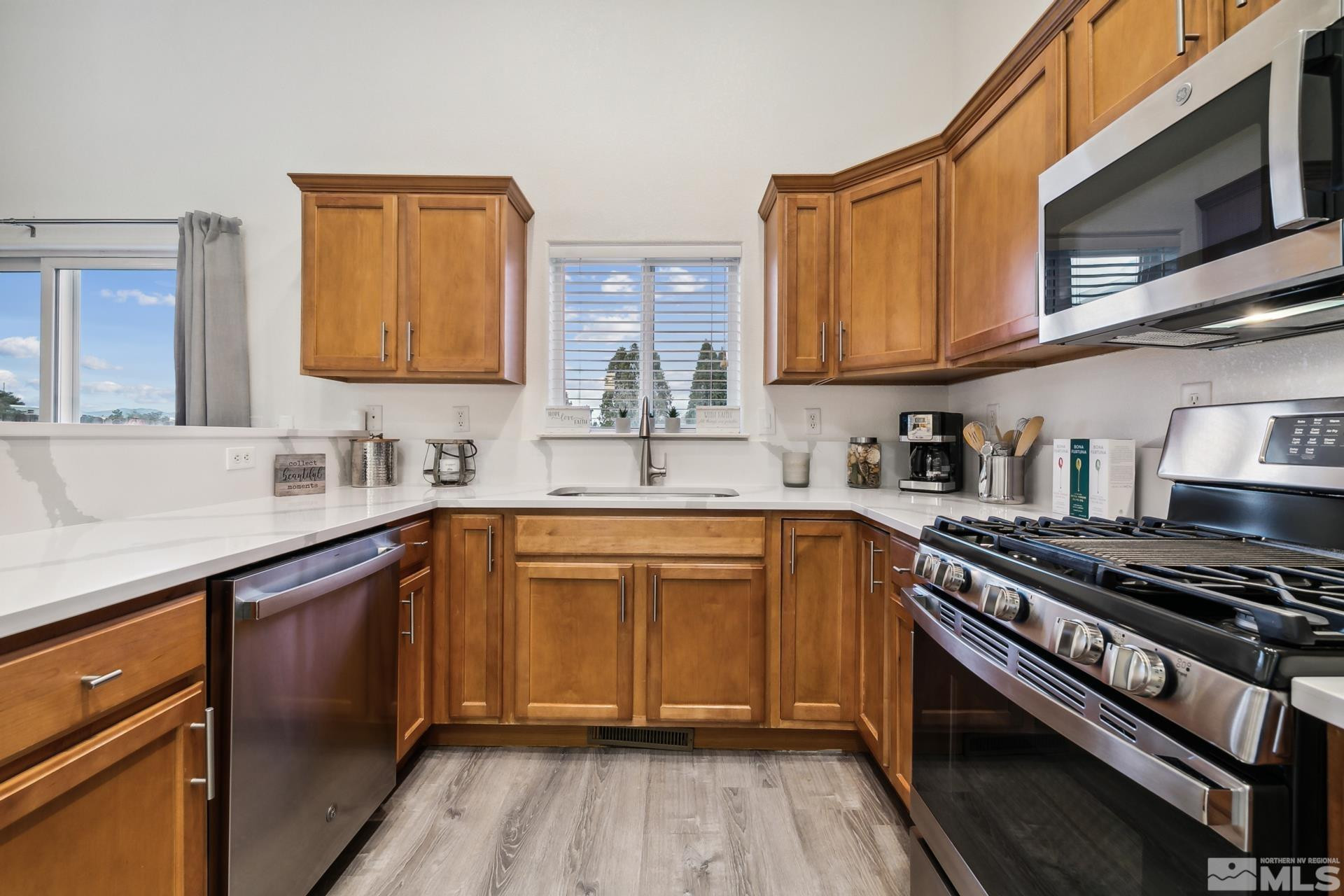 10 Conner Way Gardnerville, NV 89410 - Photo 23 of 40 a kitchen with stainless steel appliances granite countertop a sink stove and refrigerator