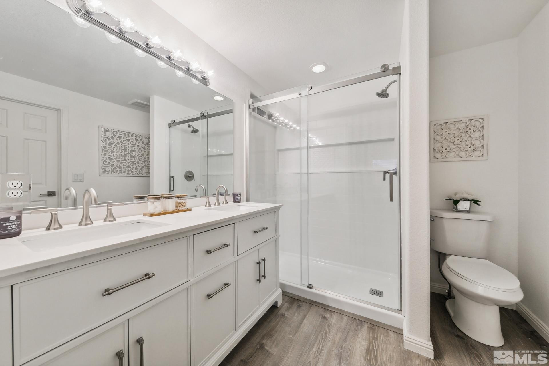 10 Conner Way Gardnerville, NV 89410 - Photo 27 of 40 a bathroom with a double vanity sink toilet mirror and shower