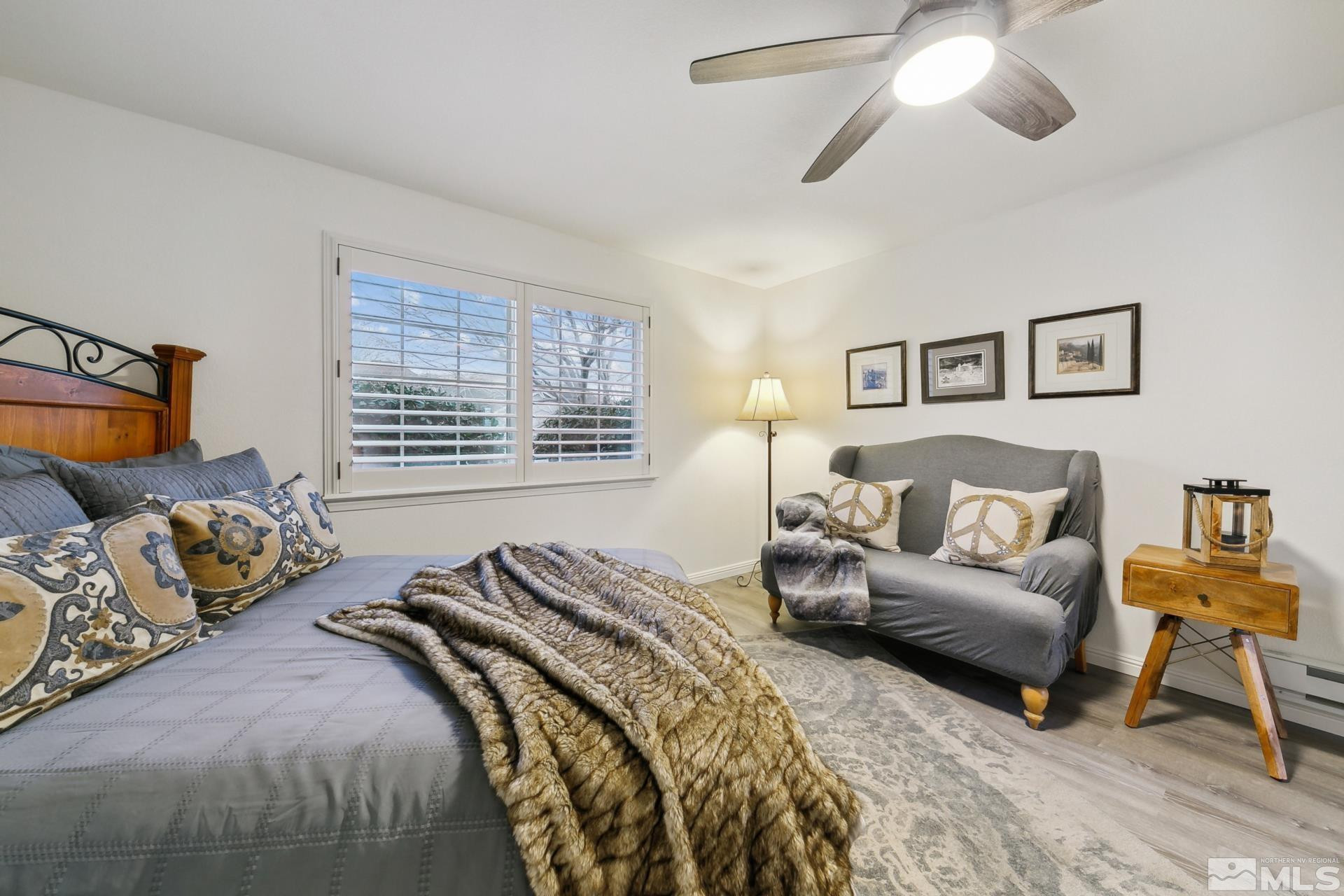 10 Conner Way Gardnerville, NV 89410 - Photo 31 of 40 a spacious bedroom with a bed a couch and a chandelier