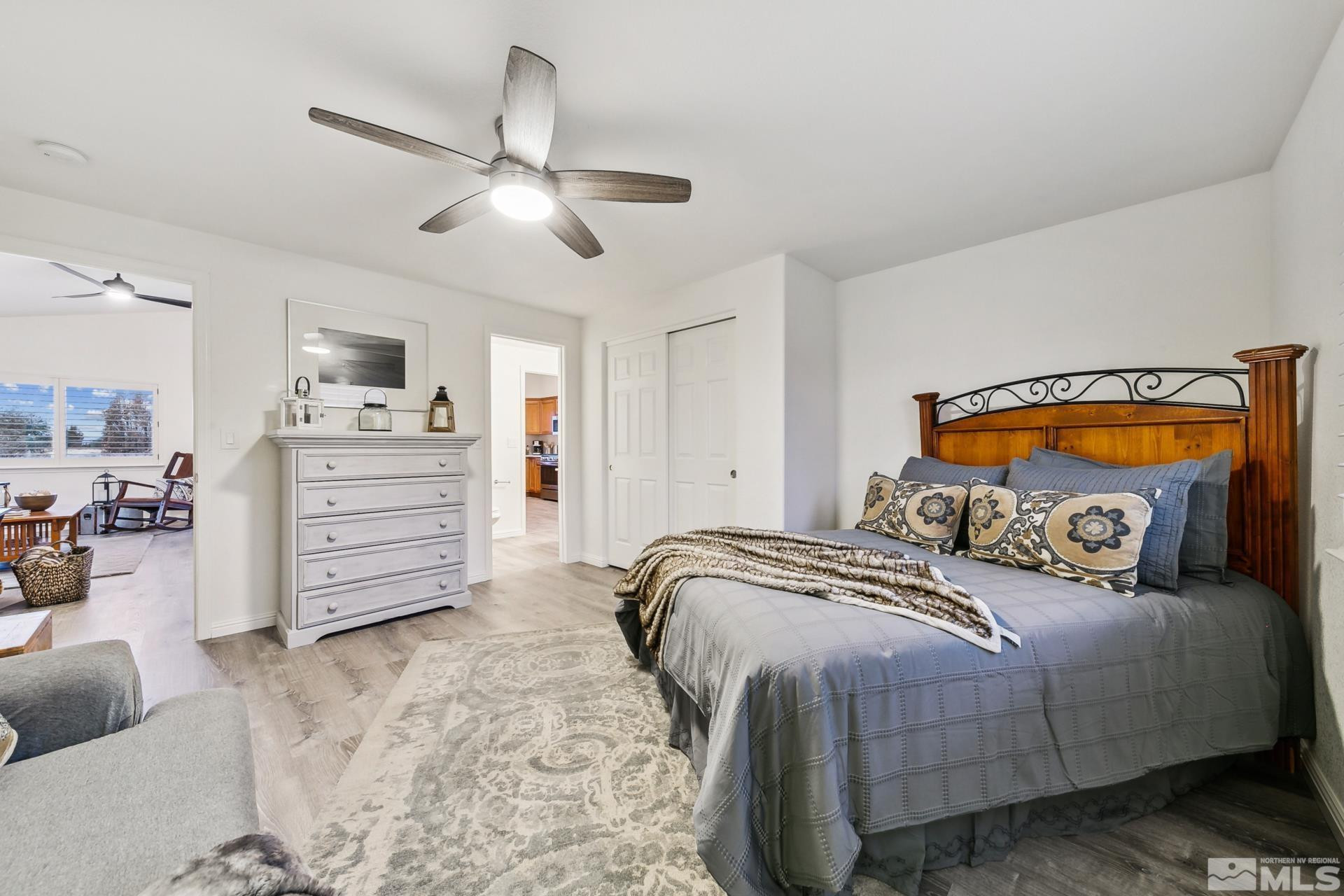 10 Conner Way Gardnerville, NV 89410 - Photo 32 of 40 a bedroom with a bed and a chandelier