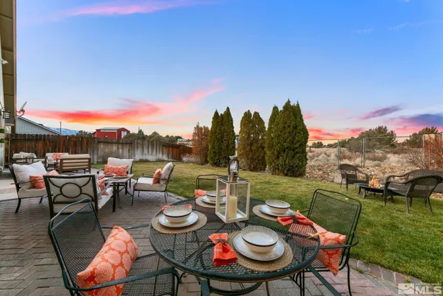 a view of a chairs and table in patio