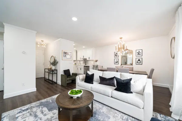 a living room with furniture and a wooden floor