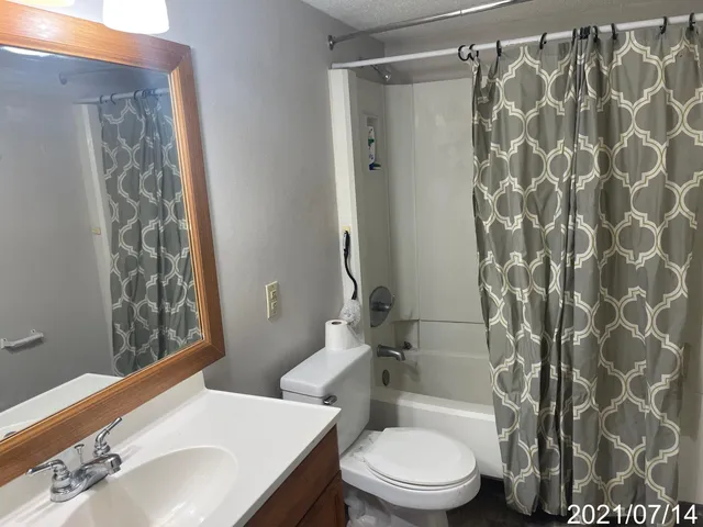 a white toilet sitting next to a bathroom sink