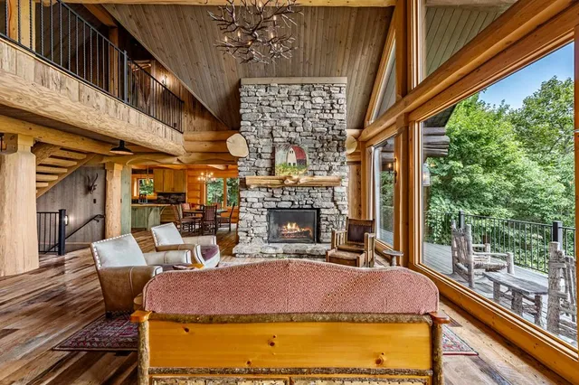 a bed sitting in a spacious bedroom next to a window and a table