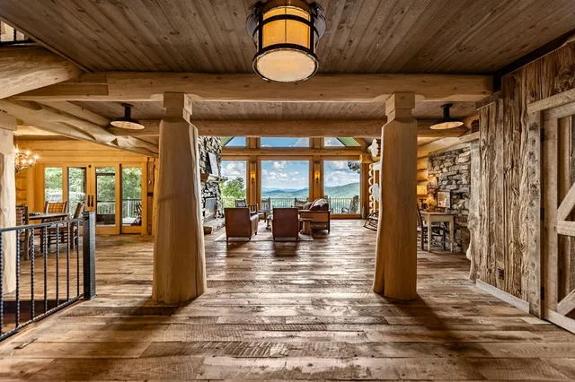 a view of a patio with table and chairs and wooden floor