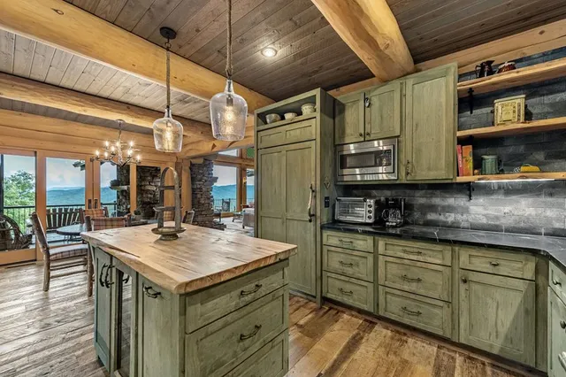 a kitchen with stainless steel appliances granite countertop a refrigerator and a stove