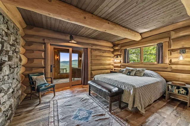 a living room with furniture and a floor to ceiling window