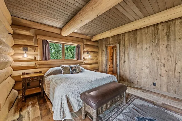 a bedroom with a bed and a mirror