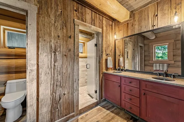 a bathroom with a window and a shower
