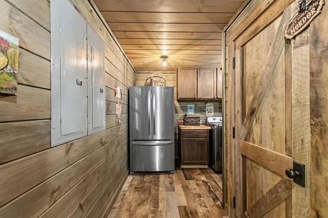 a balcony with wooden floor and outdoor seating