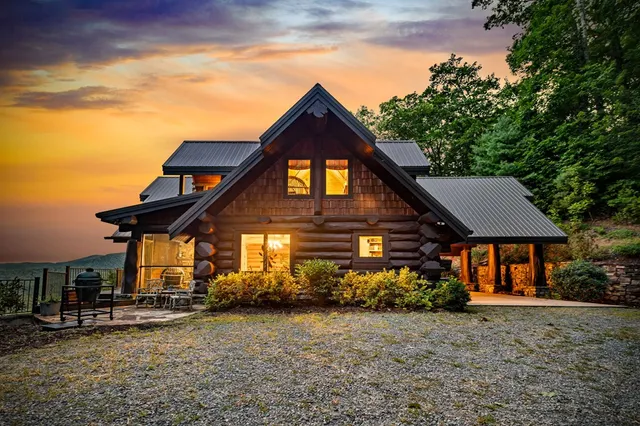 a view of a house with porch and wooden fence