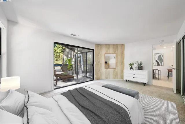 a bedroom with a large bed and a large window