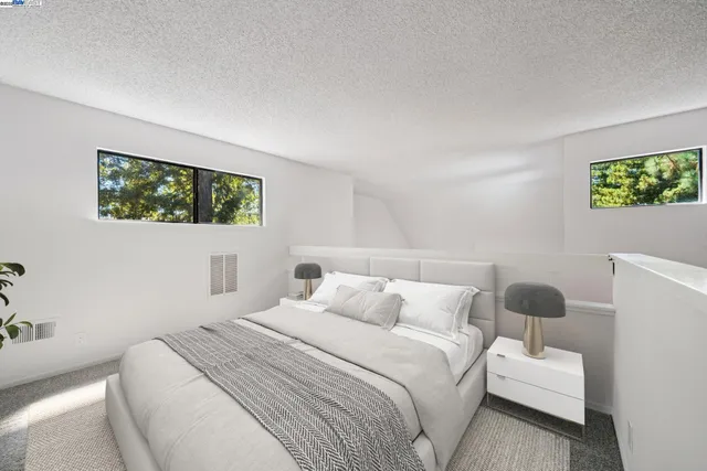 a bedroom with a bed and a painting on the wall