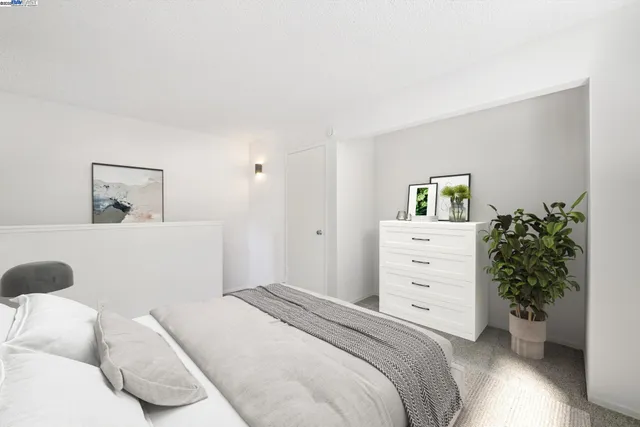 a bedroom with a bed and a potted plant