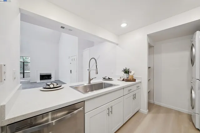 a kitchen with sink a stove and refrigerator
