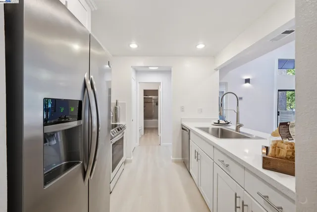 a spacious bathroom with a double sink and mirror