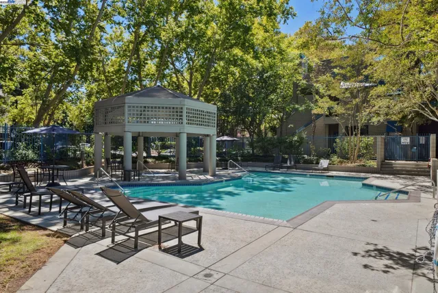 a view of a patio with table and chairs and potted plants