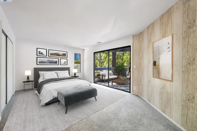 a bedroom with a large bed and a large window