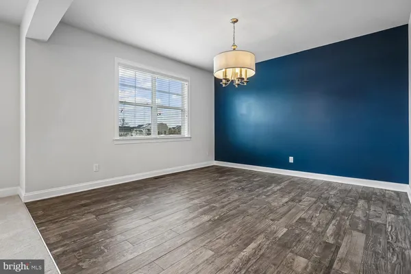 a kitchen with stainless steel appliances granite countertop a refrigerator a stove and a sink with wooden floor