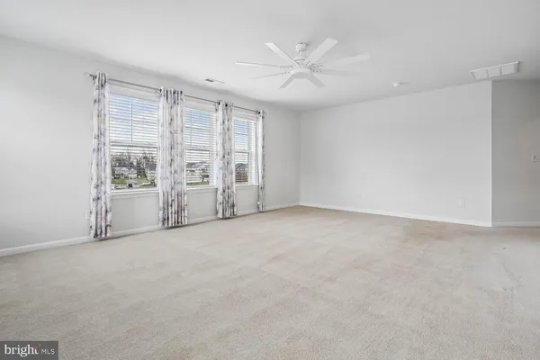 a bathroom with a bathtub and next to a window