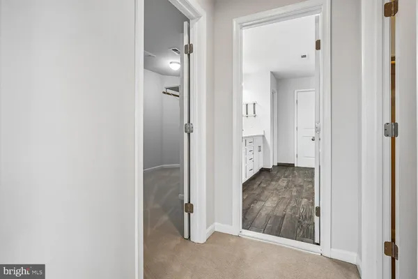 an empty room with a ceiling fan and a bathroom
