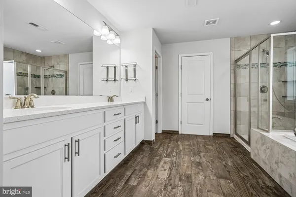 a view of a room with a ceiling fan and a bathroom
