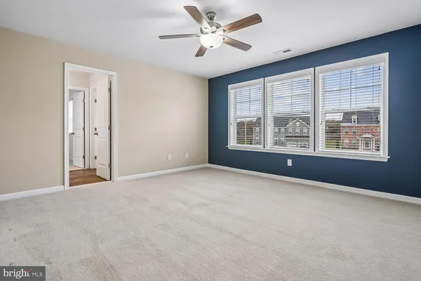 a view of a livingroom with a ceiling fan and window