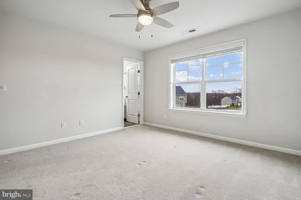 a view of a house with a yard and large trees