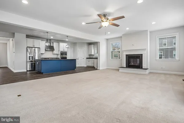 an empty room with wooden floor and window