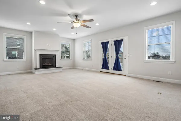 a view of empty room with wooden floor and window
