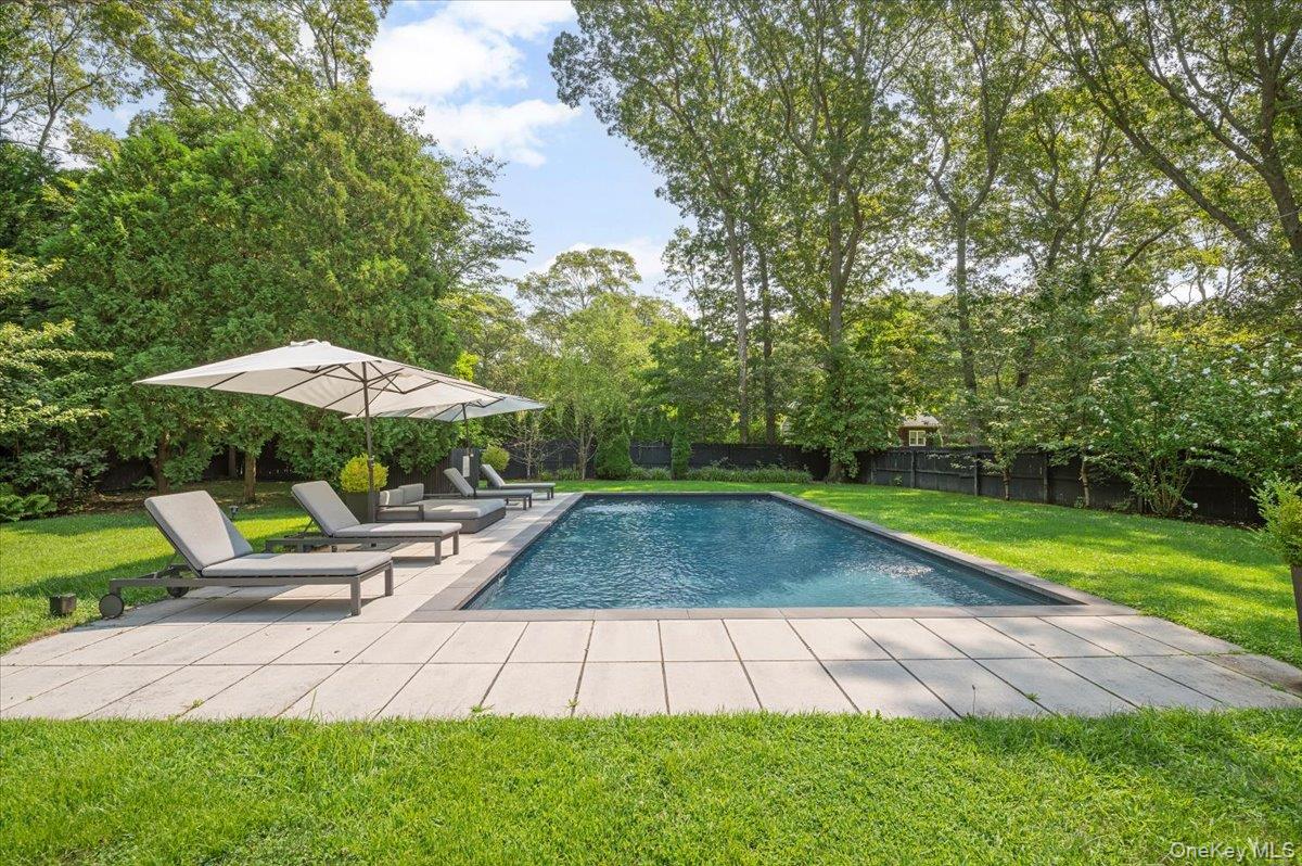 94 Hands Creek Road East Hampton, NY 11937 - Photo 1 of 31 a view of backyard with outdoor seating and trees