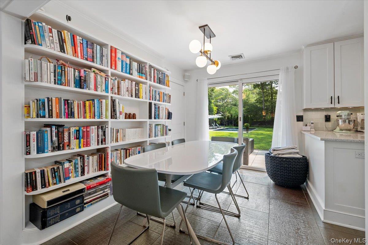 94 Hands Creek Road East Hampton, NY 11937 - Photo 12 of 31 a living room with furniture and a book shelf