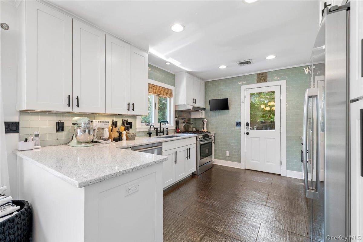94 Hands Creek Road East Hampton, NY 11937 - Photo 13 of 31 a kitchen with white cabinets and white appliances