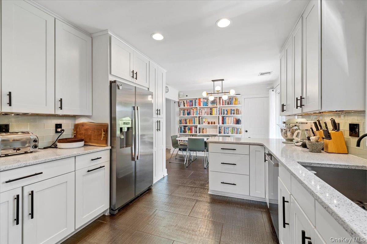 94 Hands Creek Road East Hampton, NY 11937 - Photo 15 of 31 a kitchen with white cabinets and refrigerator