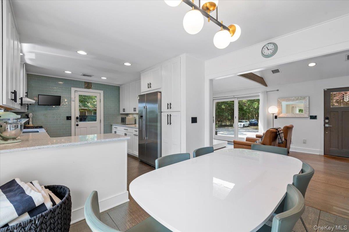 94 Hands Creek Road East Hampton, NY 11937 - Photo 16 of 31 a large white kitchen with a table and chairs