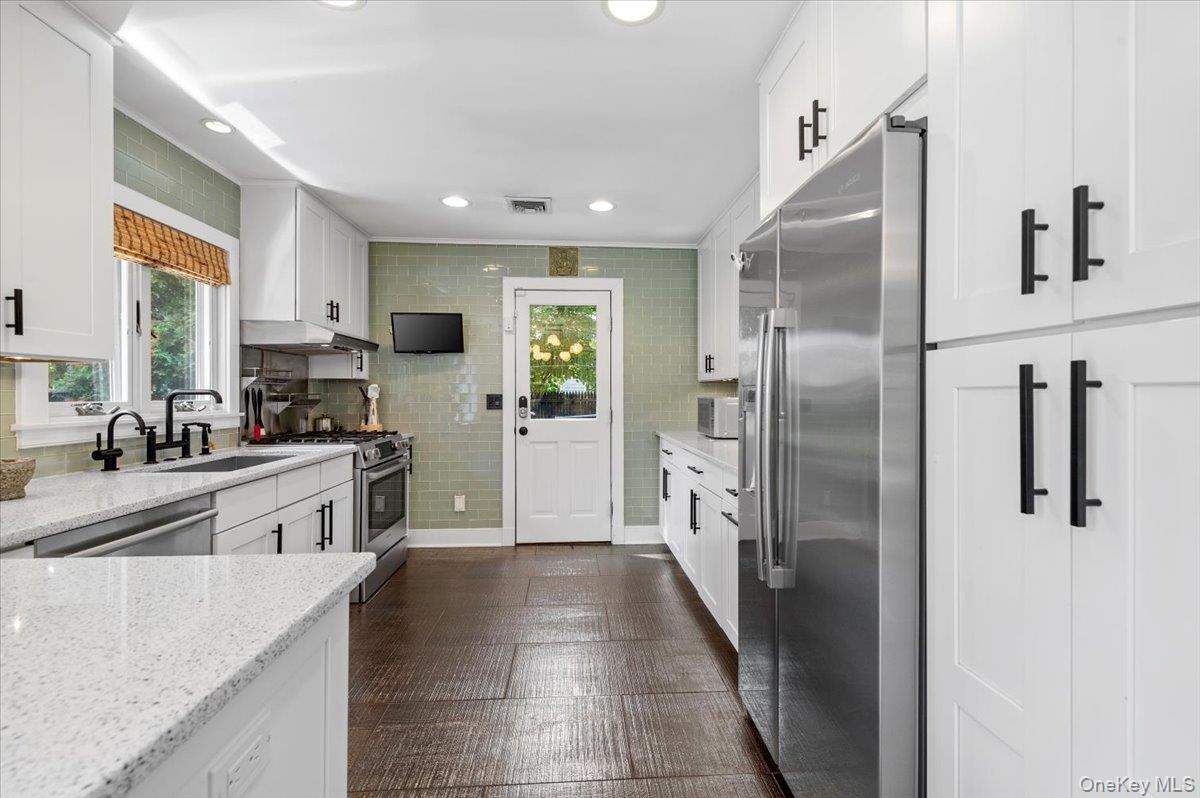 94 Hands Creek Road East Hampton, NY 11937 - Photo 17 of 31 a large kitchen with stainless steel appliances cabinets a sink and a counter top space