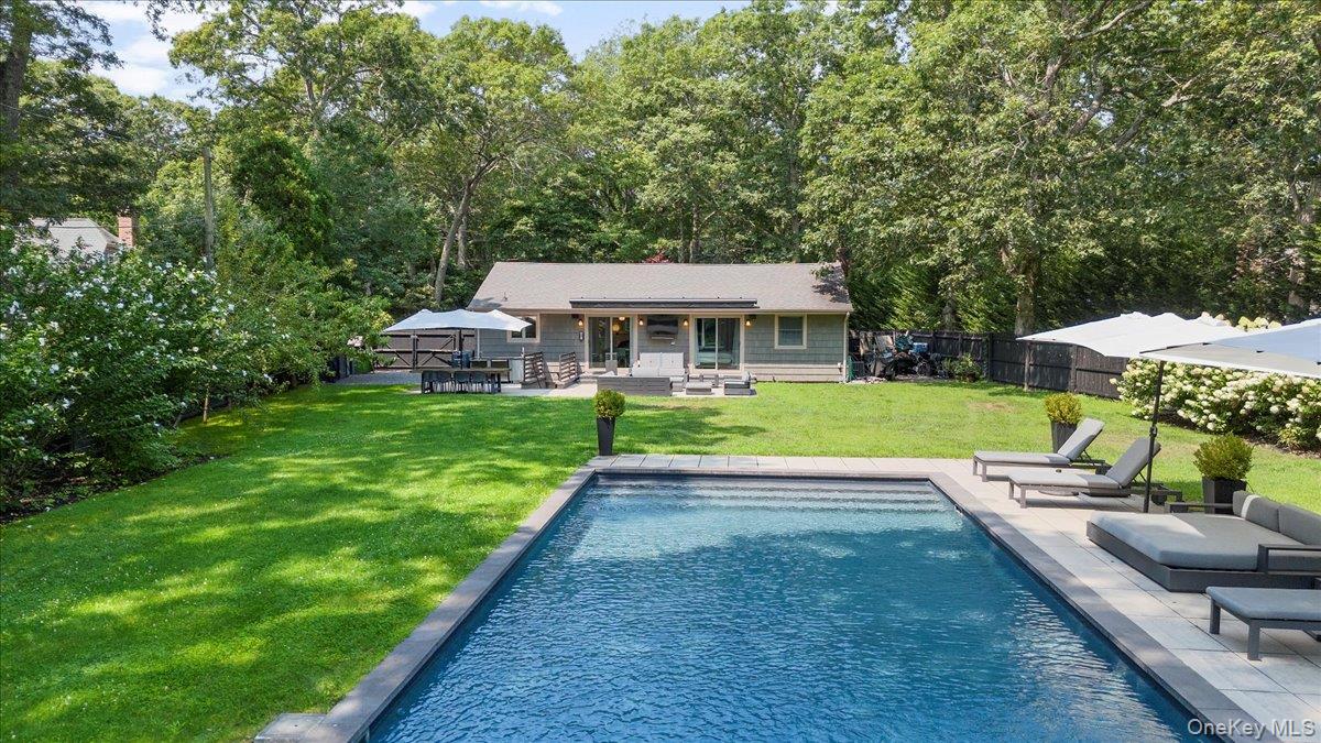 94 Hands Creek Road East Hampton, NY 11937 - Photo 2 of 31 swimming pool view with a seating space and a garden