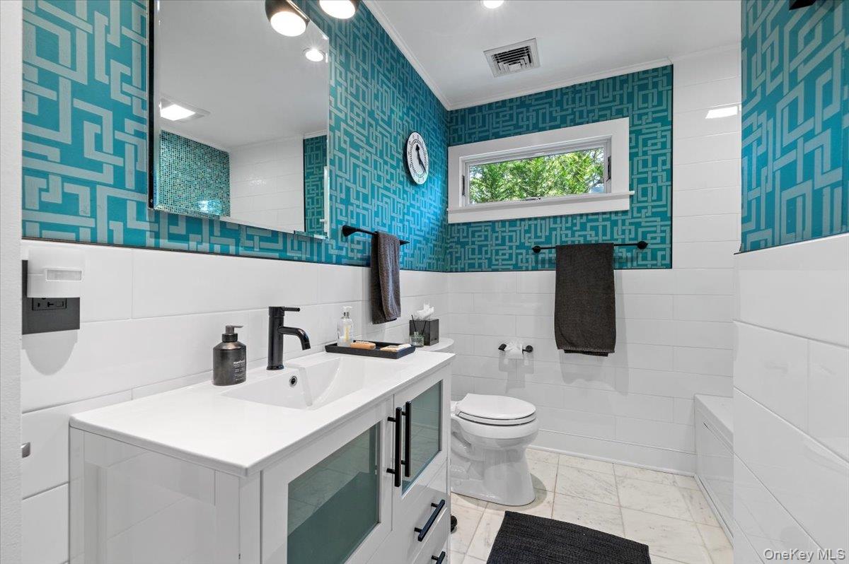94 Hands Creek Road East Hampton, NY 11937 - Photo 23 of 31 a bathroom with a toilet sink and mirror