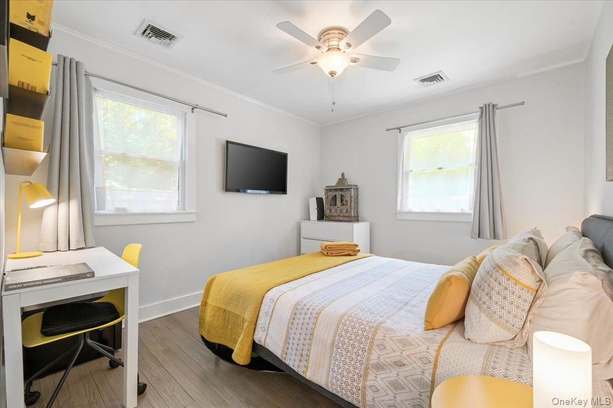 94 Hands Creek Road East Hampton, NY 11937 - Photo 24 of 31 a bedroom with a bed and a chandelier