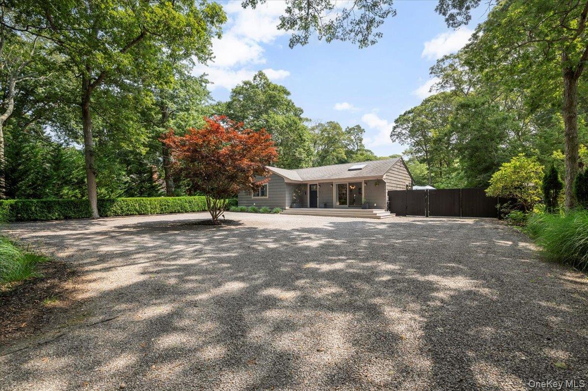94 Hands Creek Road East Hampton, NY 11937 - Photo 5 of 31 a front view of a house with a yard