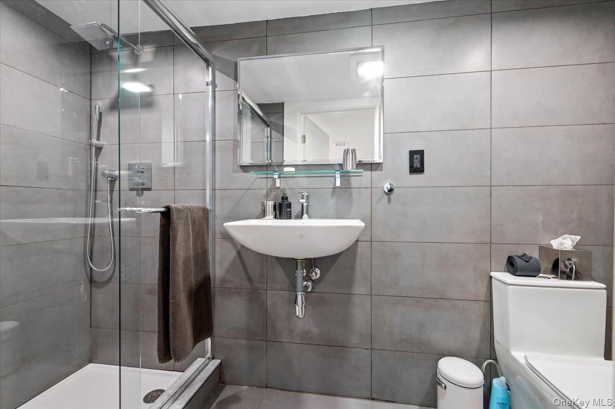 94 Hands Creek Road East Hampton, NY 11937 - Photo 9 of 31 a bathroom with a sink toilet and shower
